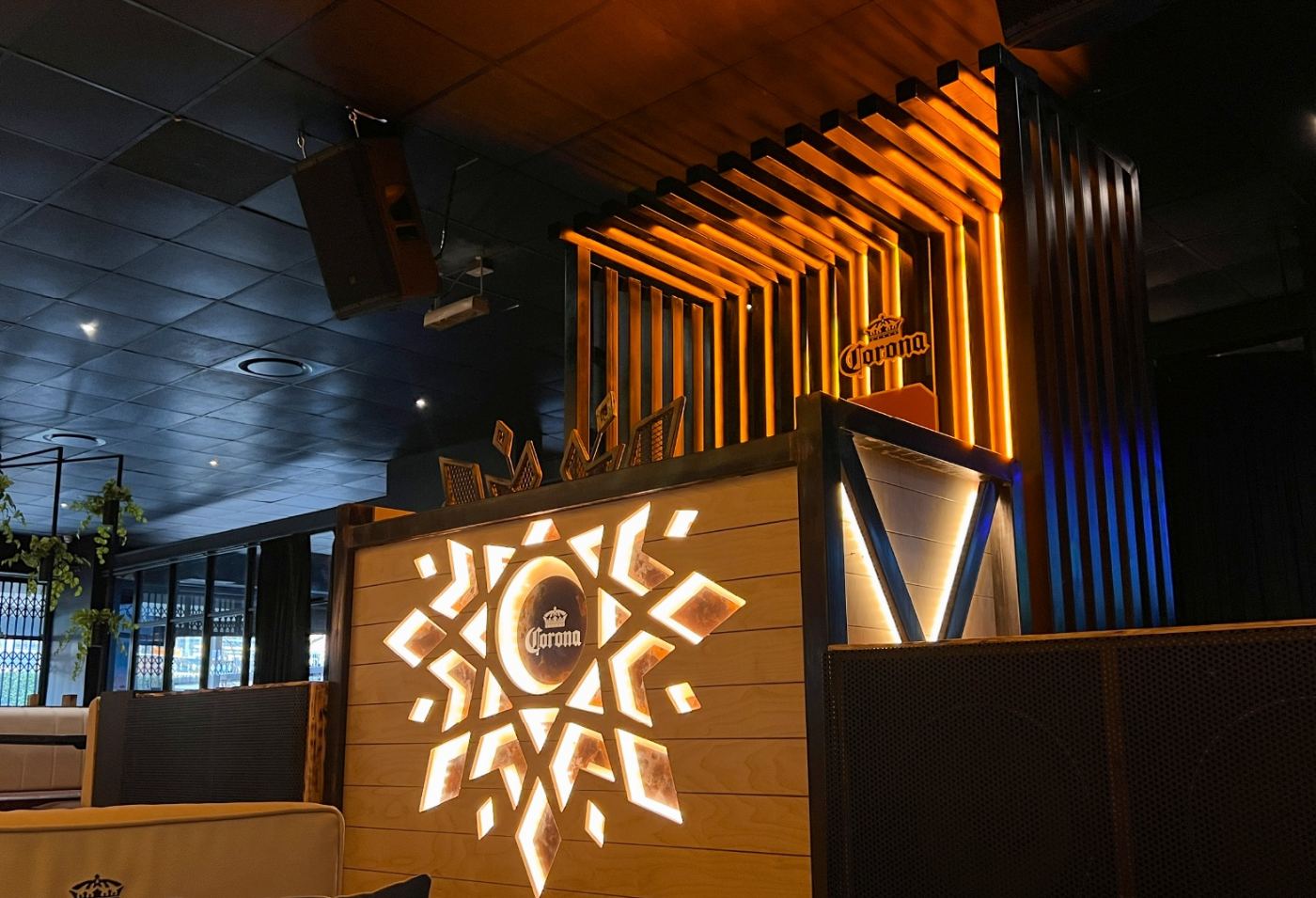 Propaganda bar with illuminated Corona feature wall and slat ceiling