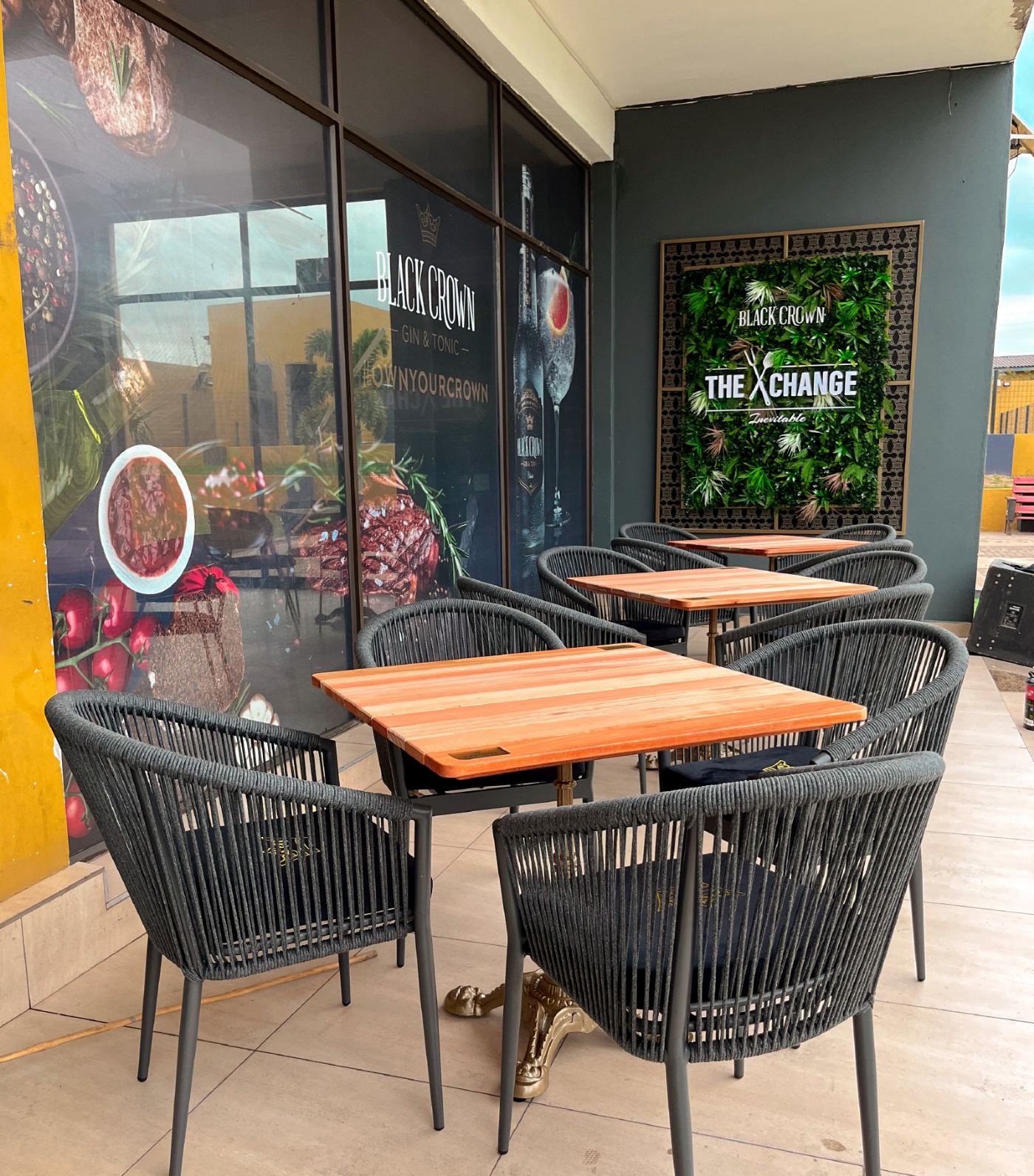 The Exchange outdoor seating with Black Crown branded signage